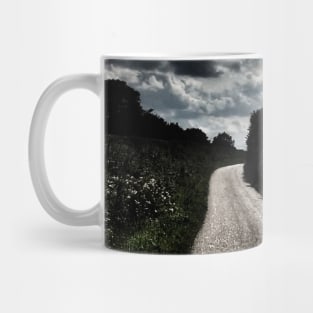 Scenic view of dramatic dark sky above winding road less traveled Mug